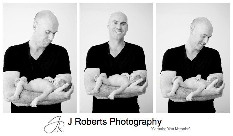 Proud daddy with newborn baby boy in his arms - newborn baby portrait photography sydney